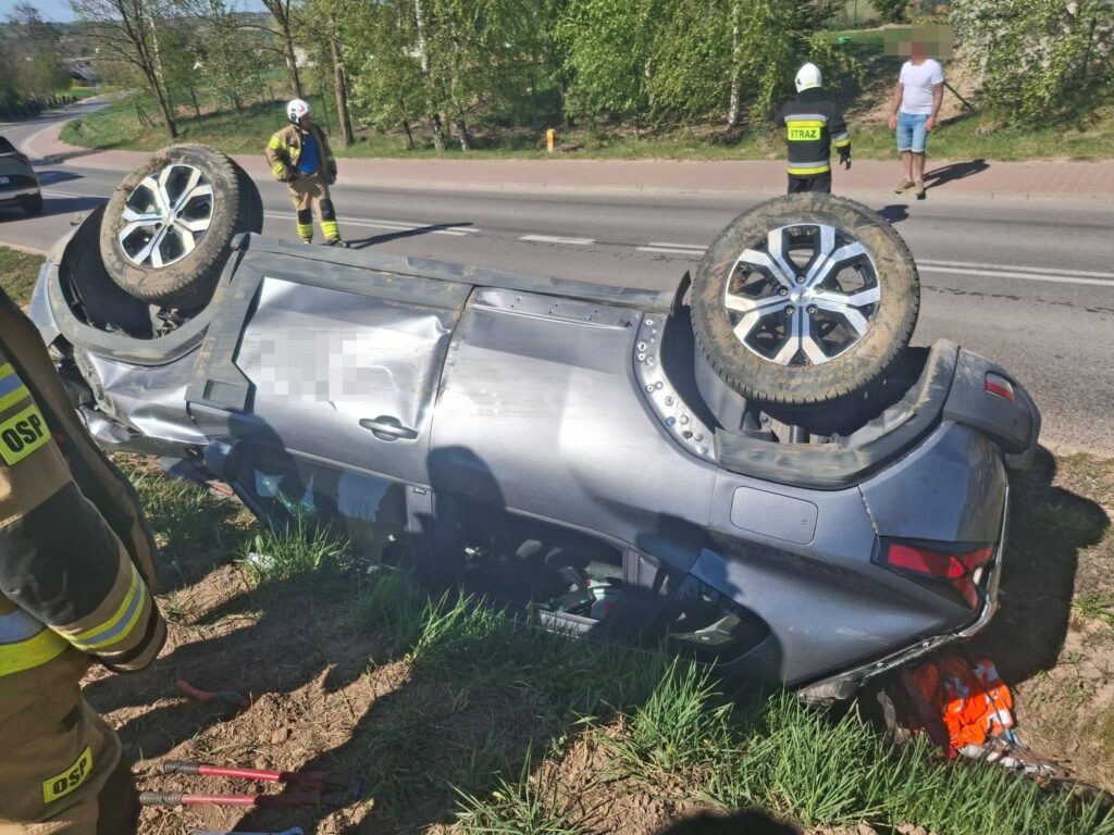 Dachowanie samochodu osobowego w Wieloborowicach, auto na dachu przy drodze, działania strażaków JRG Starachowice i OSP Ambrożów